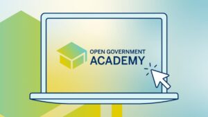 Illustration eines stilisierten, geöfffneten Laptops mit OpenNRW-Logo, gestaltet mit Pastellfarben und Farbverläufen