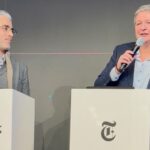 Ein Mann und eine Frau stehen hinter Rednerpulten der New York Times auf einer Bühne der Münchner Sicherheitskonferenz 2026.