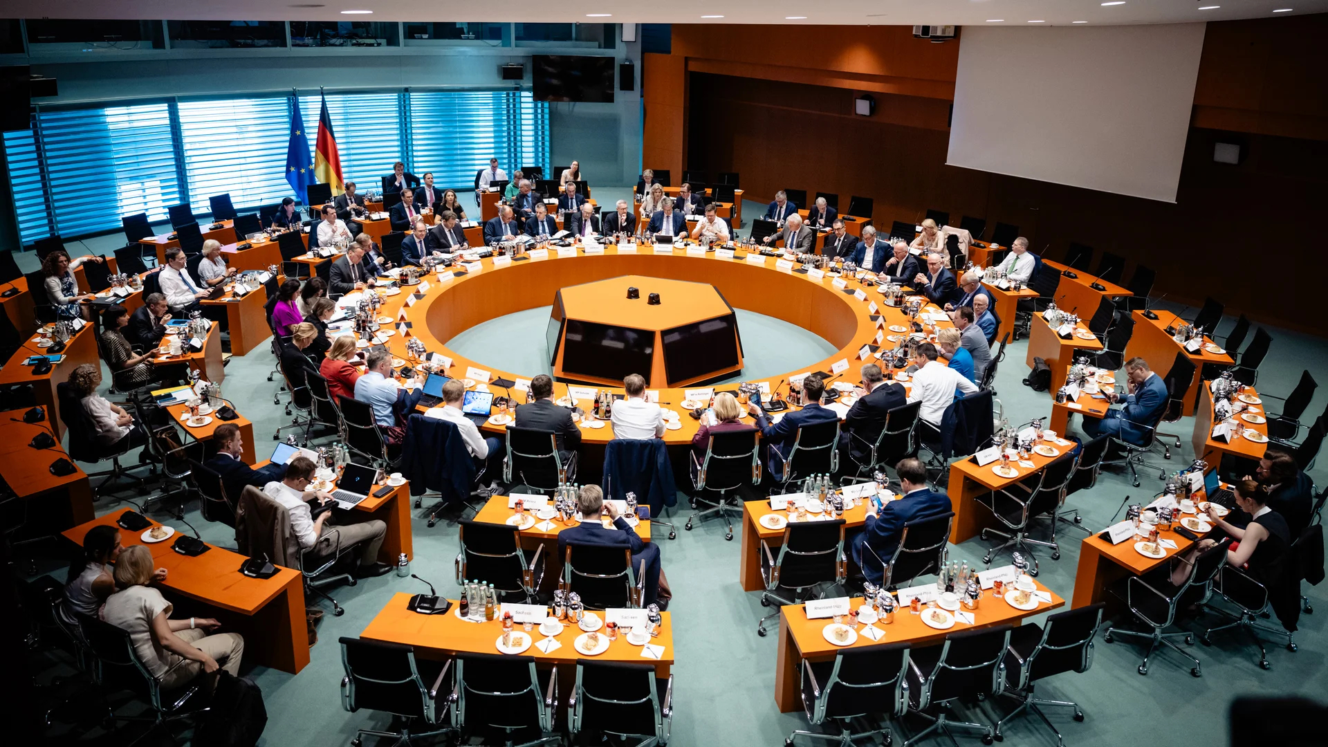 Tagungssaal mit runder Tischanordnung, gut besetzt