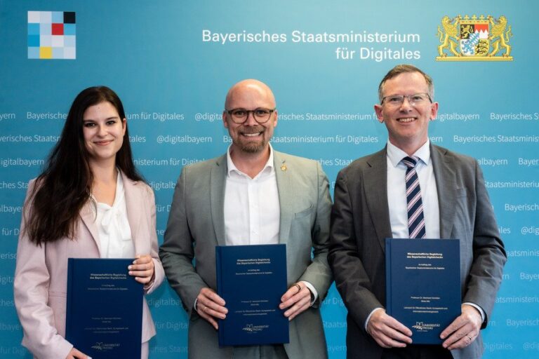 Drei steif lächelnde Menschen stehen nebeneinander vor einer blauen Wand und halten Doklumentenmappen in ihren Händen.